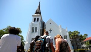 Mourners pay their respects outside Emanuel African Methodist Episcopal Church after the street was re-opened a day after a mass shooting left nine dead during a bible study at the church in Charleston